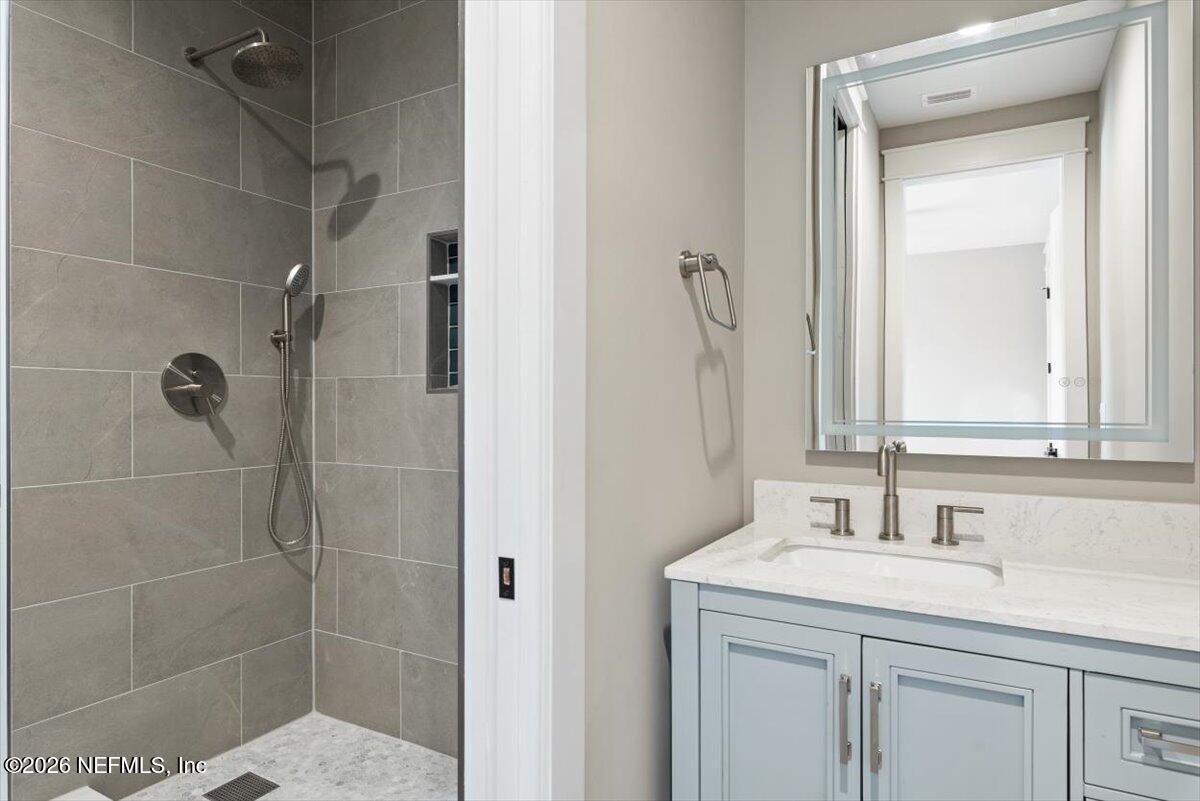34883 Steeple Chase Way Callahan, FL 32011 - Photo 51 of 88 a bathroom with a shower sink and mirror