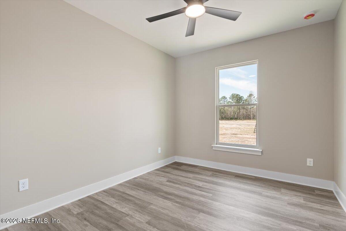 34883 Steeple Chase Way Callahan, FL 32011 - Photo 52 of 88 en empty room with wooden floor and windows