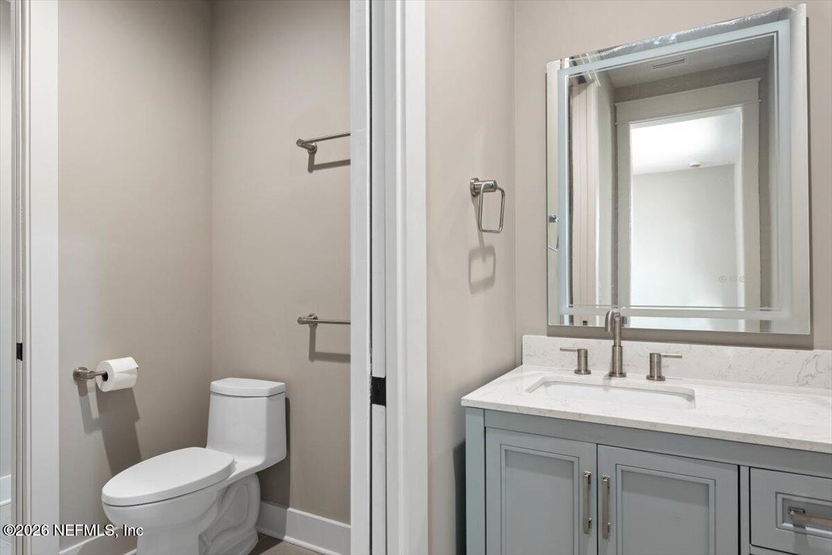 34883 Steeple Chase Way Callahan, FL 32011 - Photo 54 of 88 a bathroom with a granite countertop sink toilet and a mirror