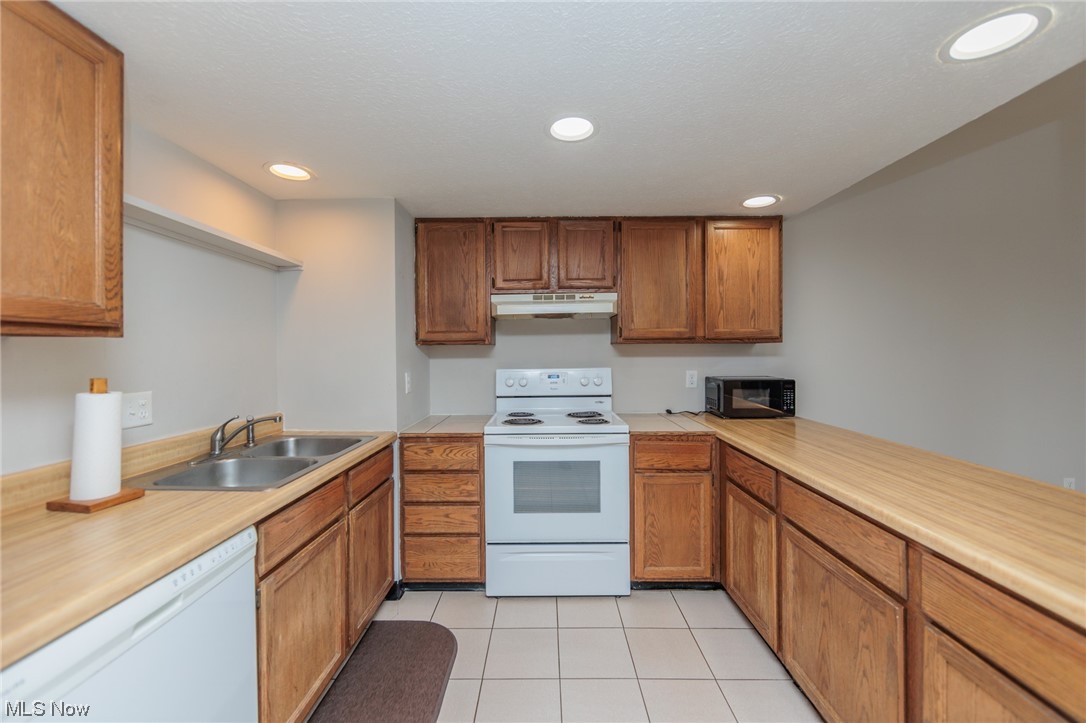 2406 Call Road Stow, OH 44224 - Photo 10 of 30 Kitchen with sink, white appliances, and light tile floors