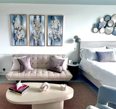 a bedroom with a bed and painting on the wall