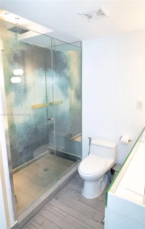 a bathroom with a shower and a toilet