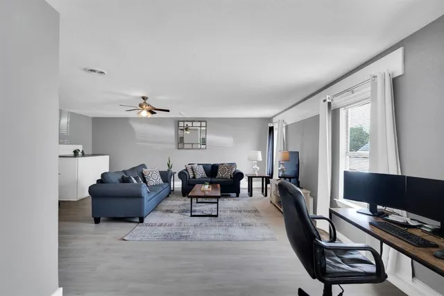 a living room with furniture and wooden floor