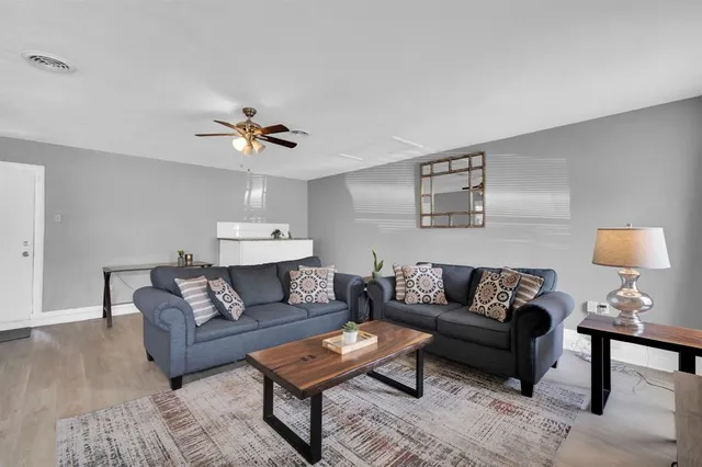 a living room with furniture and a lamp