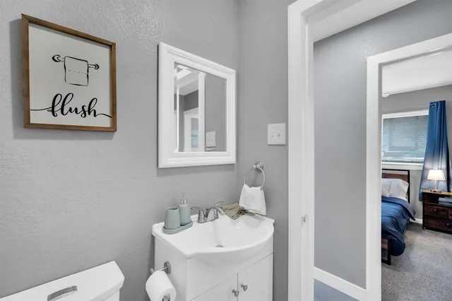 a bathroom with a toilet sink and mirror