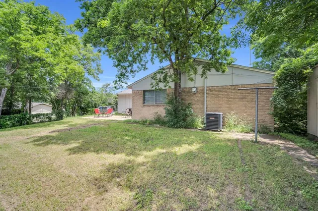 a front view of house with yard and trees