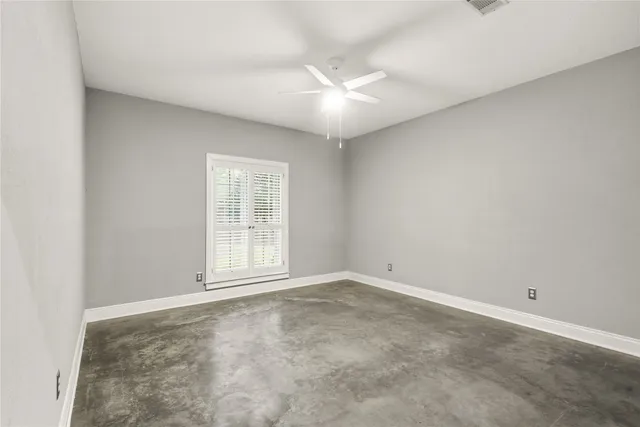 an empty room with windows and closet