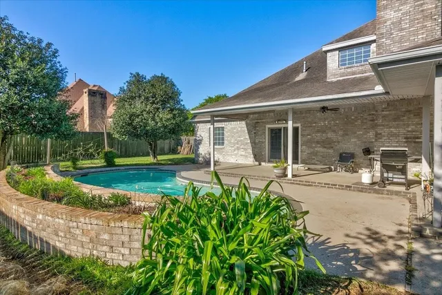 front view of a house with a yard and trees
