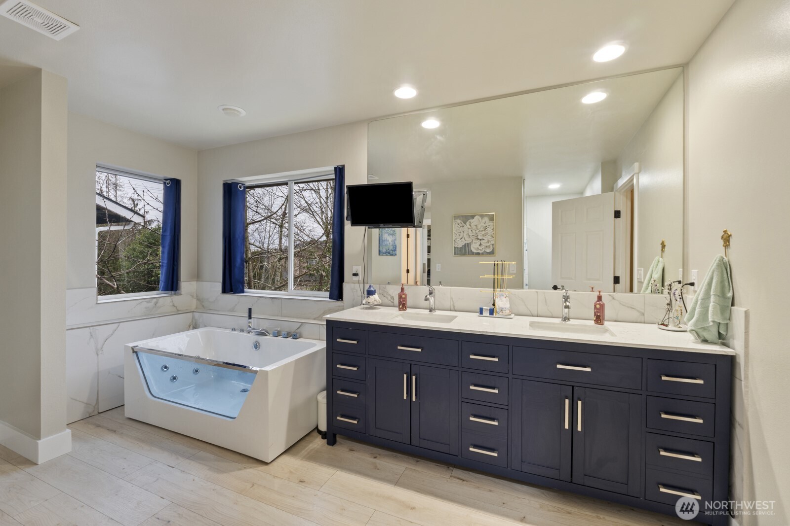 4233 154th Place Southeast Bothell, WA 98012 - Photo 30 of 40 a bathroom with a tub double vanity sink and mirror
