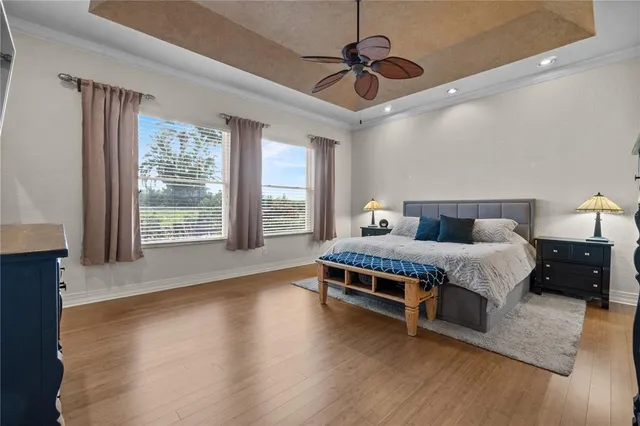 a bedroom with a bed wooden floor and window