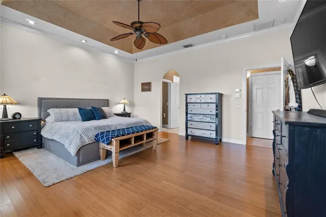 a bedroom with a bed and wooden floor