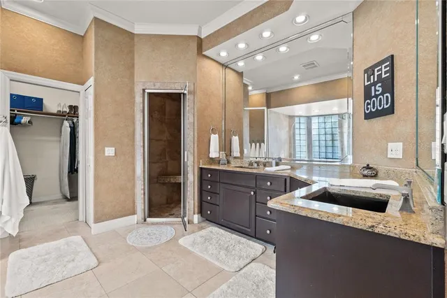 a kitchen with stainless steel appliances granite countertop a sink and a refrigerator