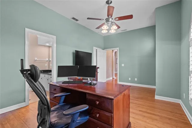 a view of a workspace with furniture and chandelier