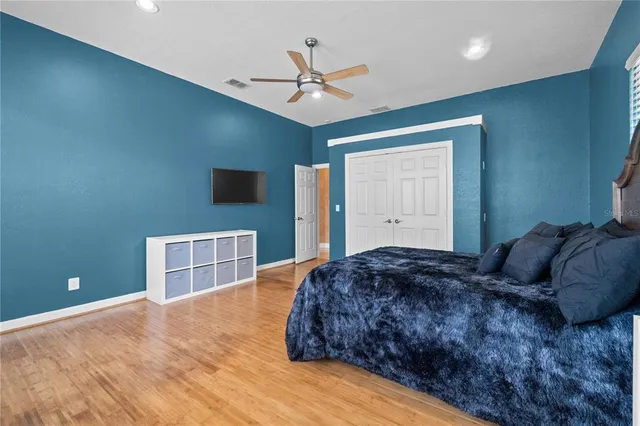 a bedroom with a large bed and a window