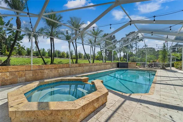 a swimming pool with outdoor seating and yard