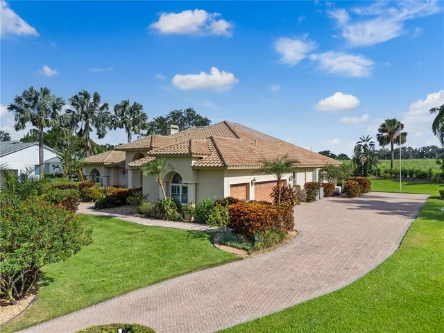 a front view of a house with a garden and yard
