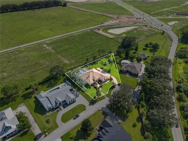 an aerial view of a house with a lake view