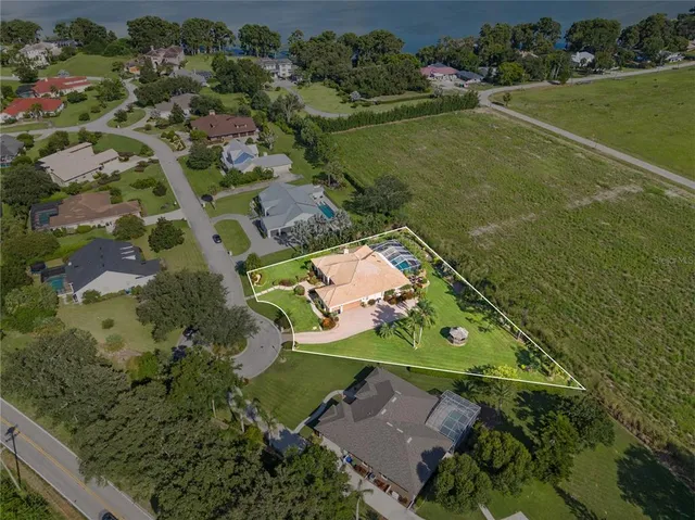 an aerial view of a house with a lake view
