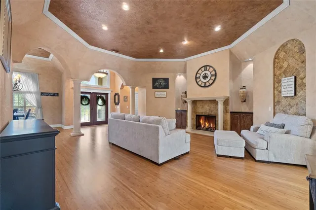 a living room with furniture a fireplace and a flat screen tv