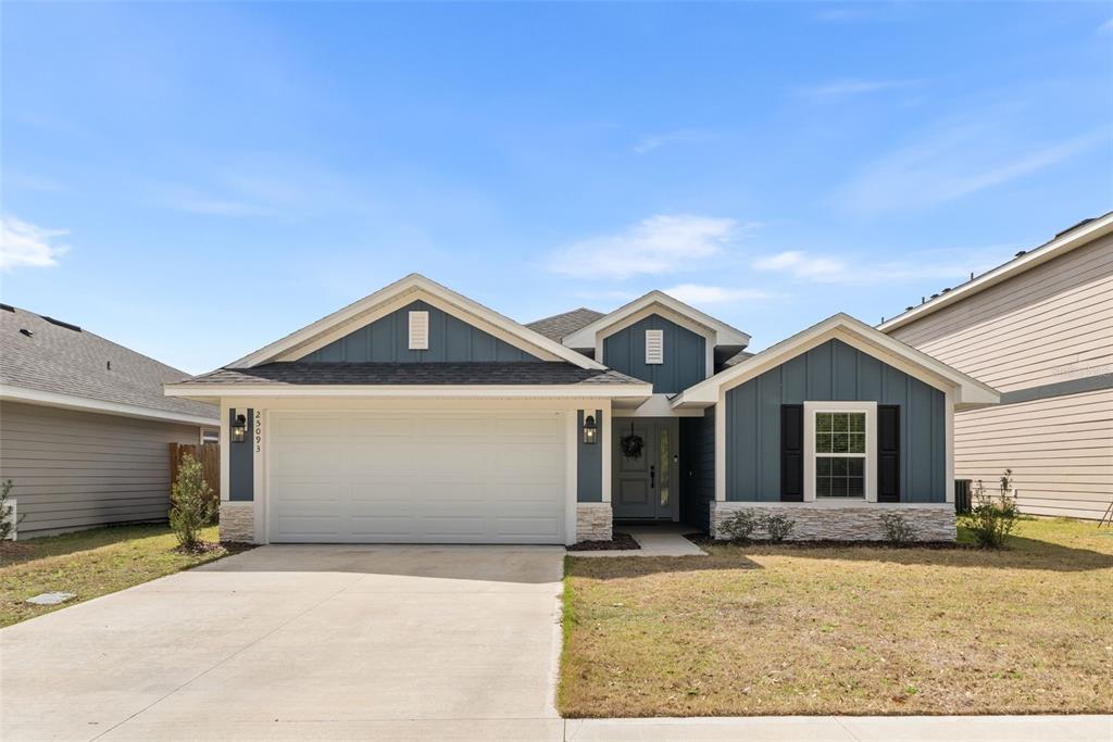 25093 Southwest 23rd Road Newberry, FL 32669 - Photo 1 of 29 a front view of a house with yard