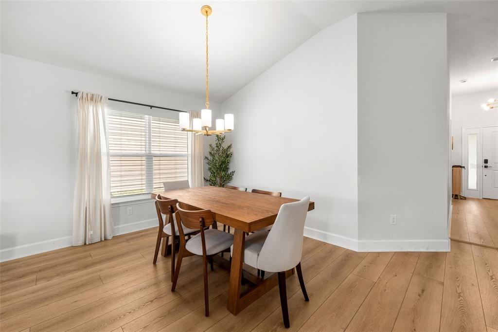 25093 Southwest 23rd Road Newberry, FL 32669 - Photo 13 of 29 a view of a dining room with furniture window and wooden floor