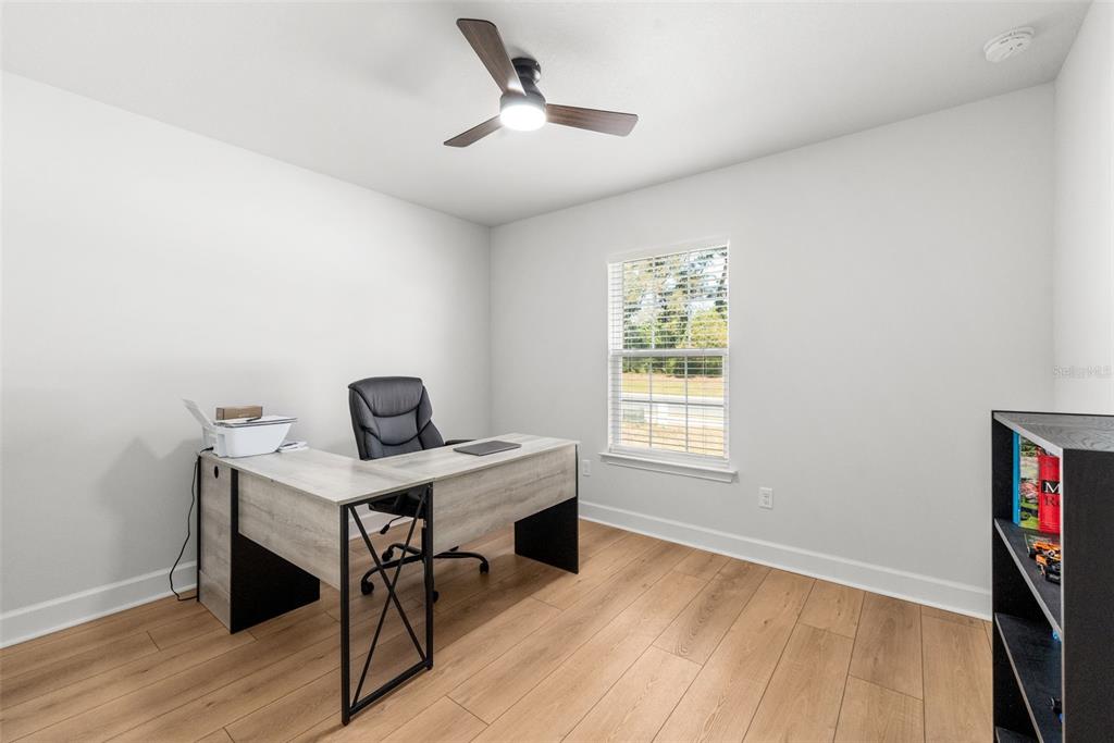 25093 Southwest 23rd Road Newberry, FL 32669 - Photo 18 of 29 a view of a workspace with furniture and a window
