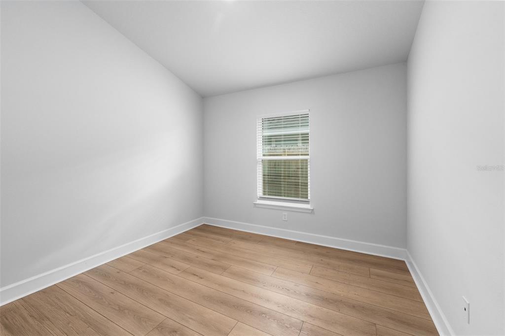 25093 Southwest 23rd Road Newberry, FL 32669 - Photo 24 of 29 an empty room with wooden floor and windows
