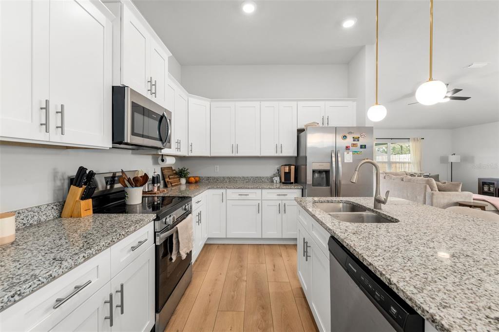 25093 Southwest 23rd Road Newberry, FL 32669 - Photo 8 of 29 a kitchen with granite countertop lots of counter top space a sink and appliances