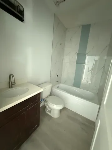 a bathroom with a toilet a sink and bathtub