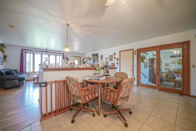 a dining room with furniture and wooden floor