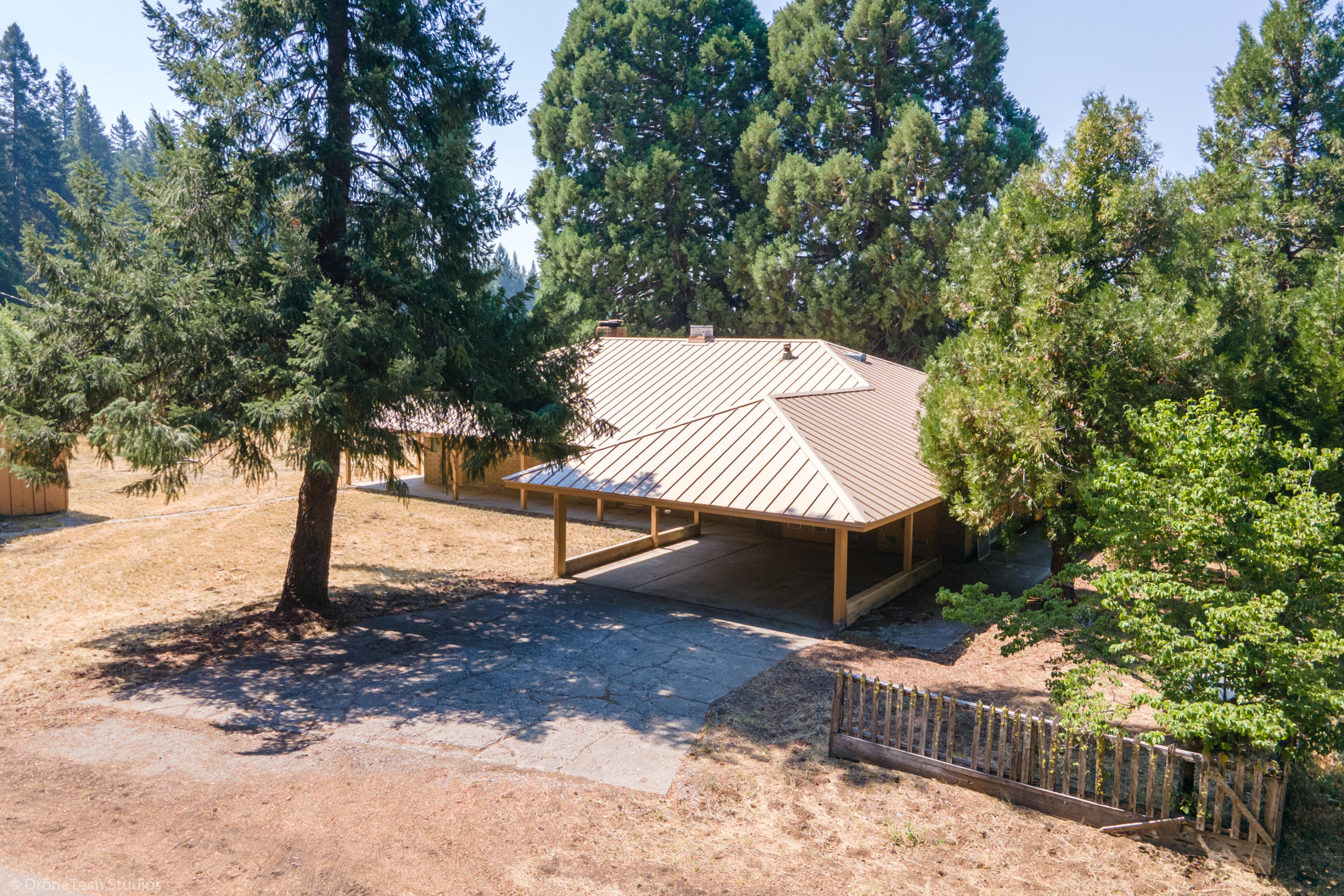 a view of a house with a yard and tree s