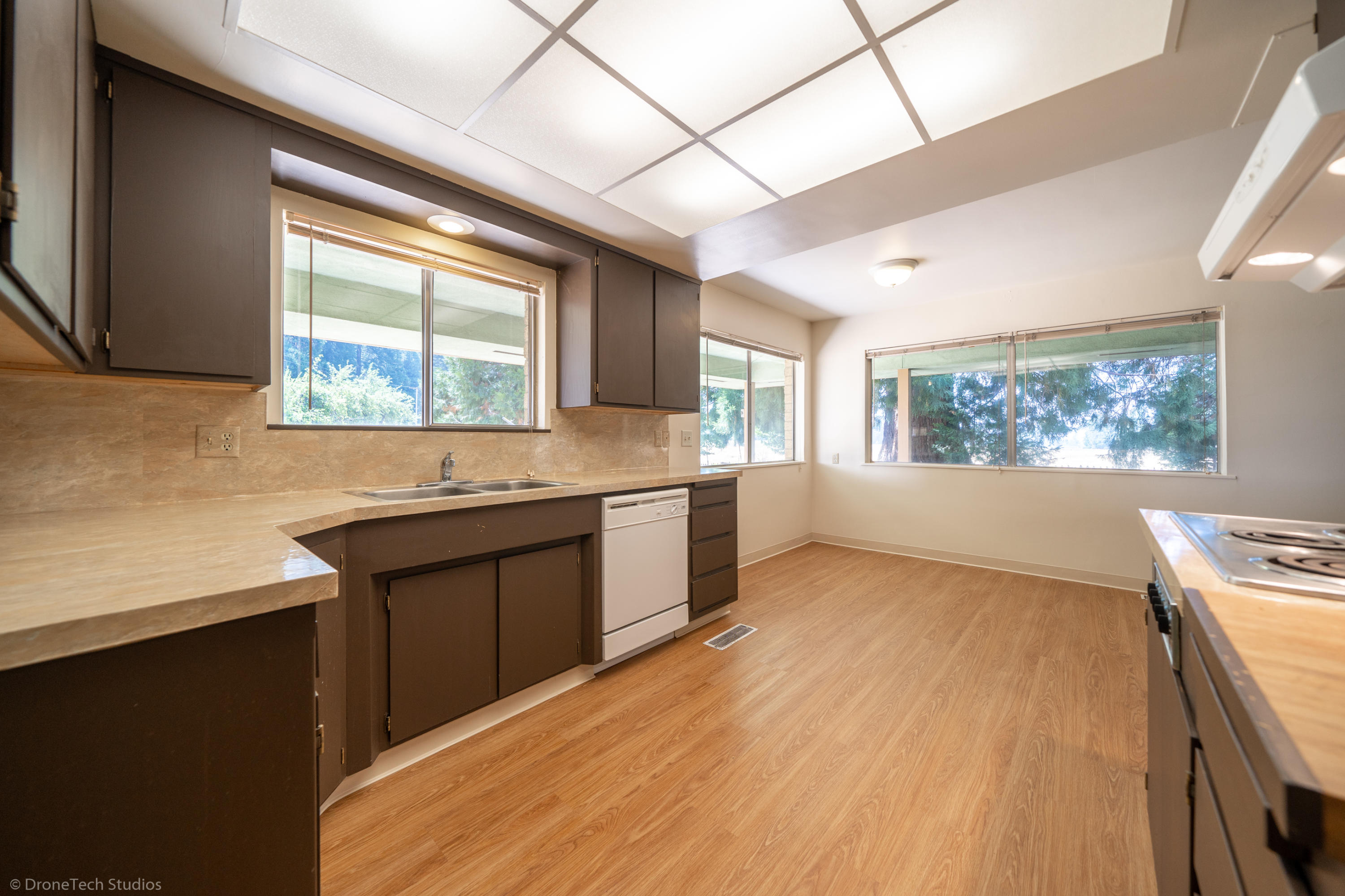 36563 Deer Flat Road Shingletown, CA 96088 - Photo 12 of 65 a kitchen with granite countertop a stove a sink and a microwave
