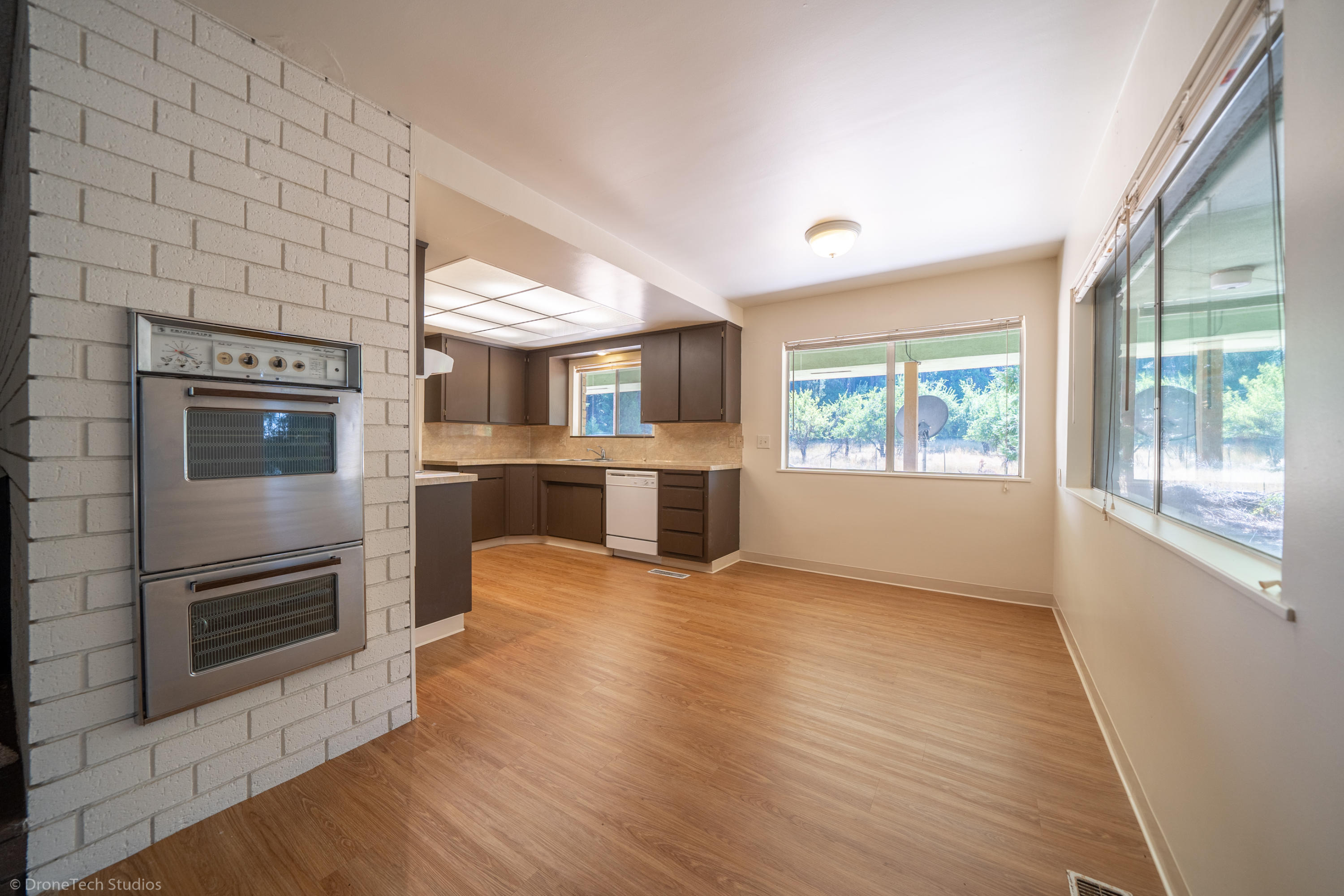 36563 Deer Flat Road Shingletown, CA 96088 - Photo 15 of 65 an empty room with windows and fireplace