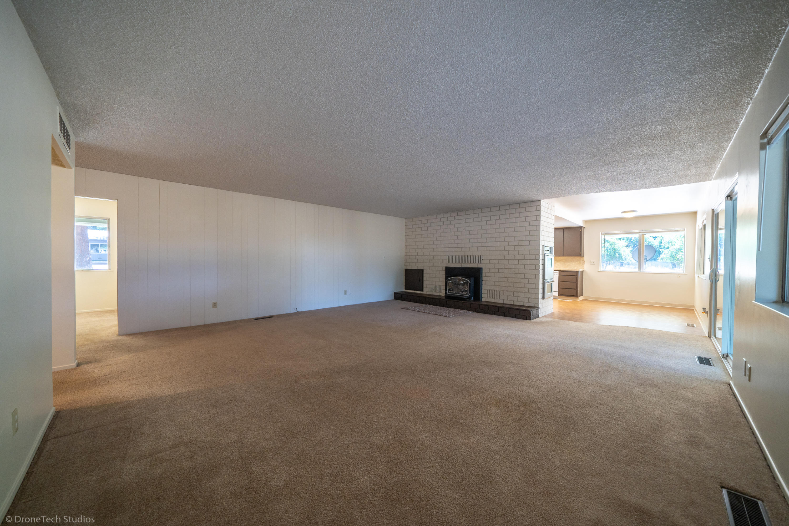 36563 Deer Flat Road Shingletown, CA 96088 - Photo 18 of 65 a view of a big room with windows and chandelier fan