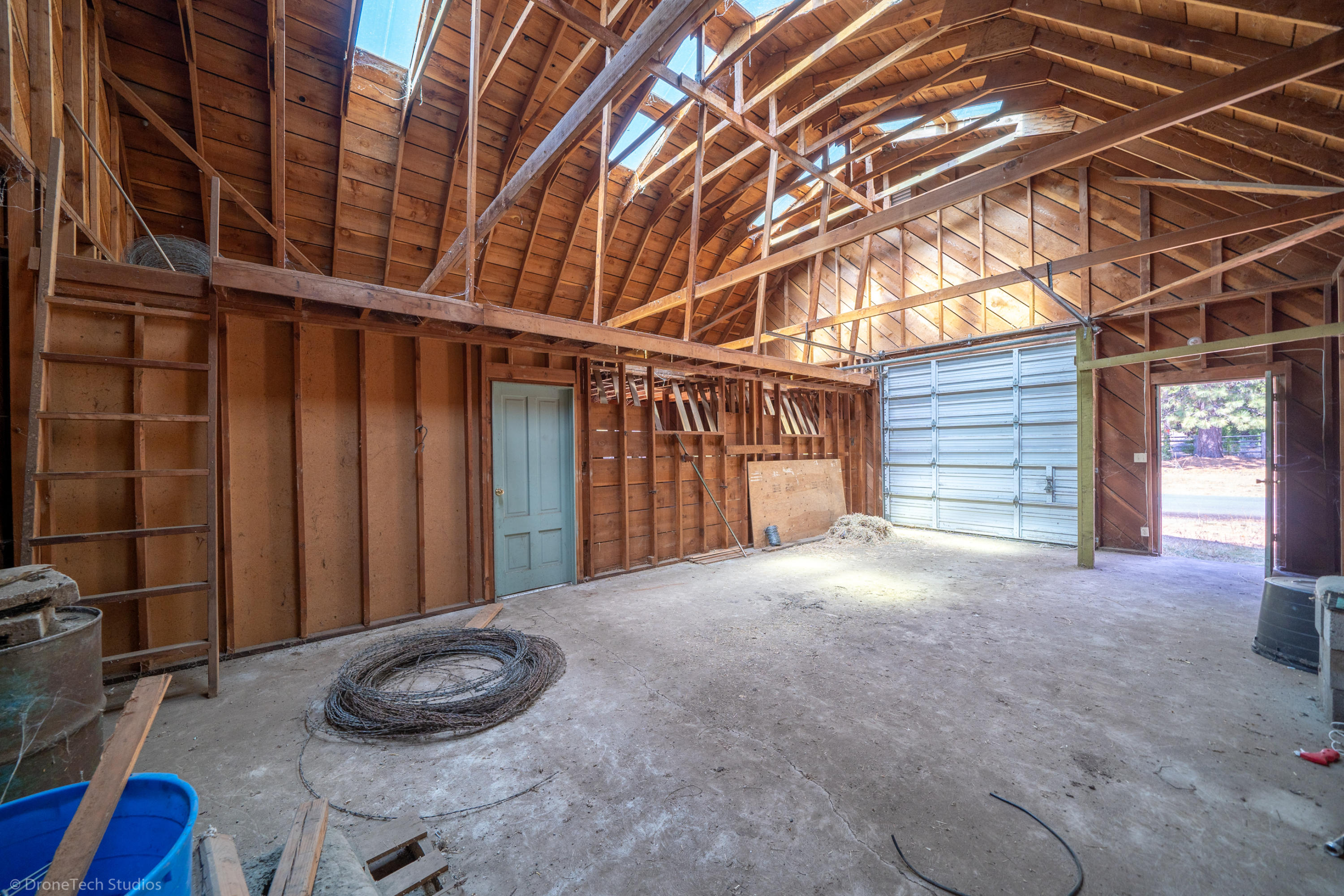 36563 Deer Flat Road Shingletown, CA 96088 - Photo 47 of 65 a view of an empty room with a wooden floor and a window