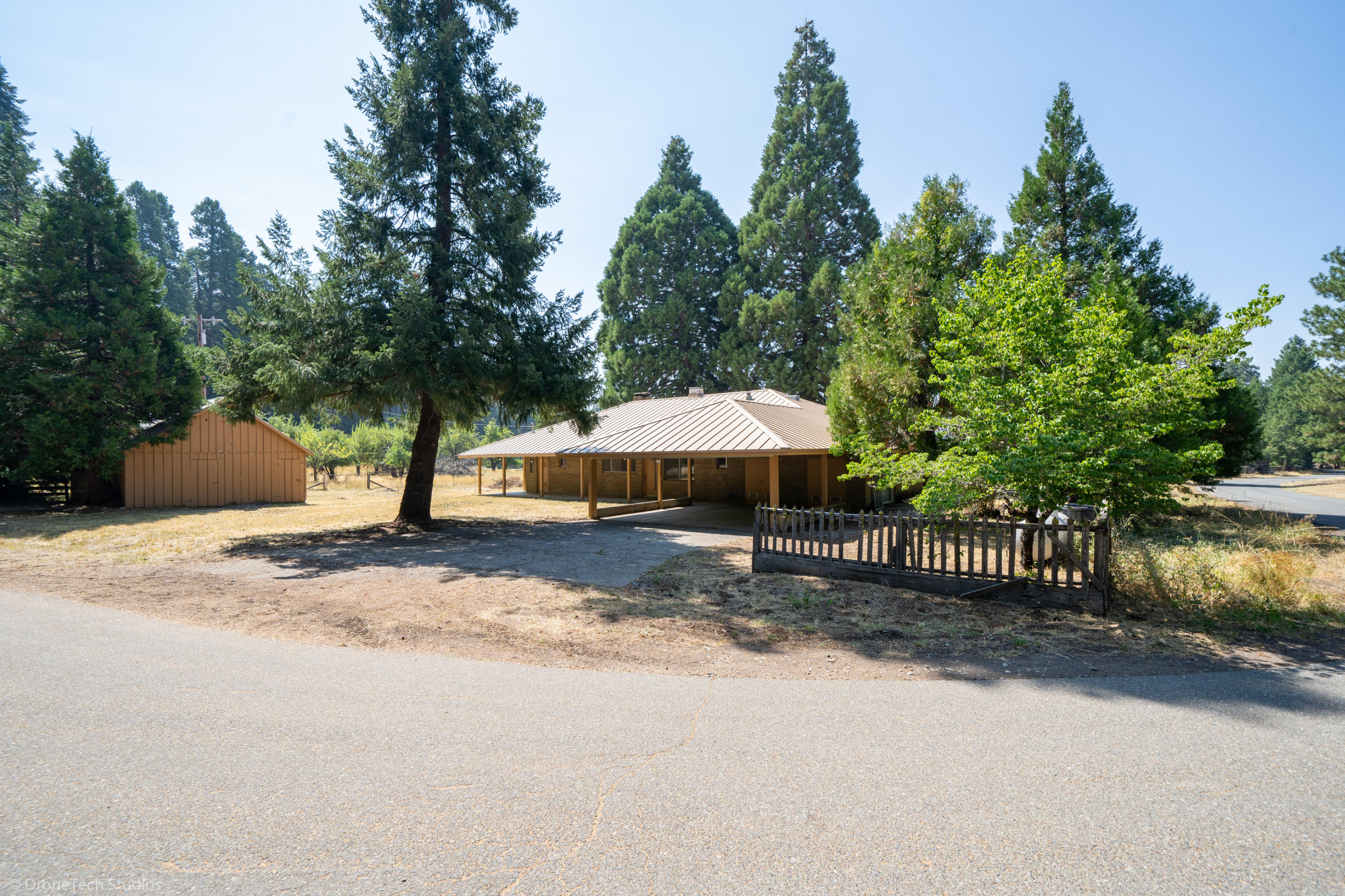 36563 Deer Flat Road Shingletown, CA 96088 - Photo 5 of 65 a backyard of a house with barbeque oven and outdoor seating