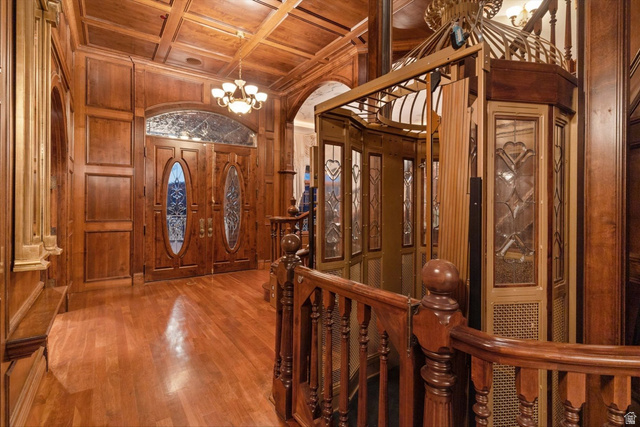 5615 East Eight Mile Gap Road Kanab, UT 84741 - Photo 25 of 81 Entrance foyer with wood ceiling, coffered ceiling, wood walls, wood finished floors, and arched walkways