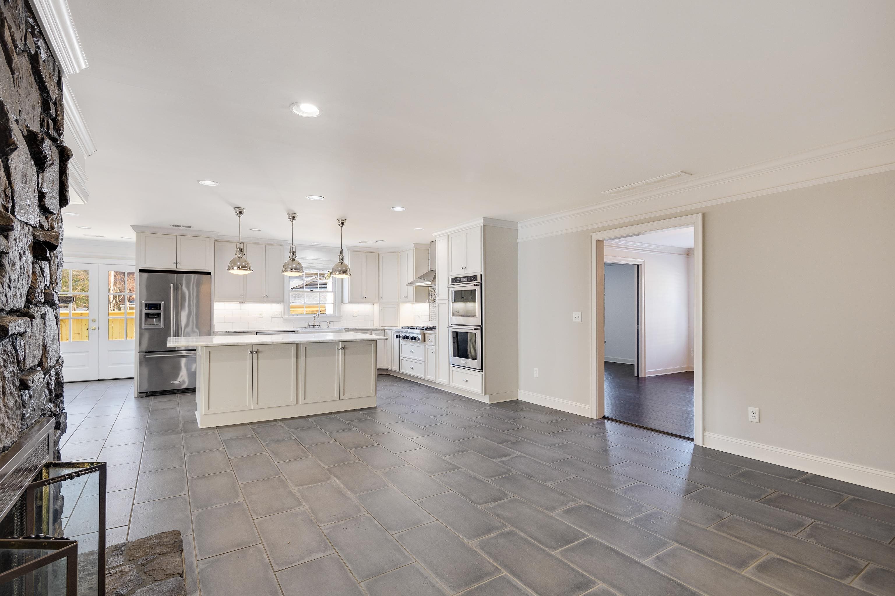 6867 River Birch Road Memphis, TN 38119 - Photo 11 of 40 Kitchen featuring a kitchen island, pendant lighting, appliances with stainless steel finishes, plenty of natural light, and crown molding