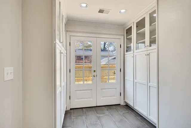 a kitchen with stainless steel appliances granite countertop white cabinets and window