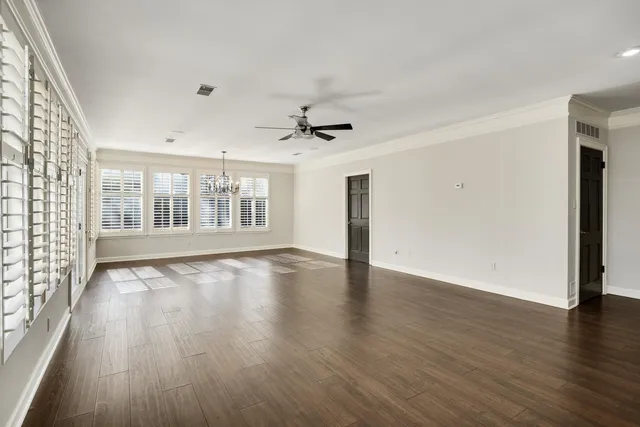 a view of empty room with wooden floor and fireplace