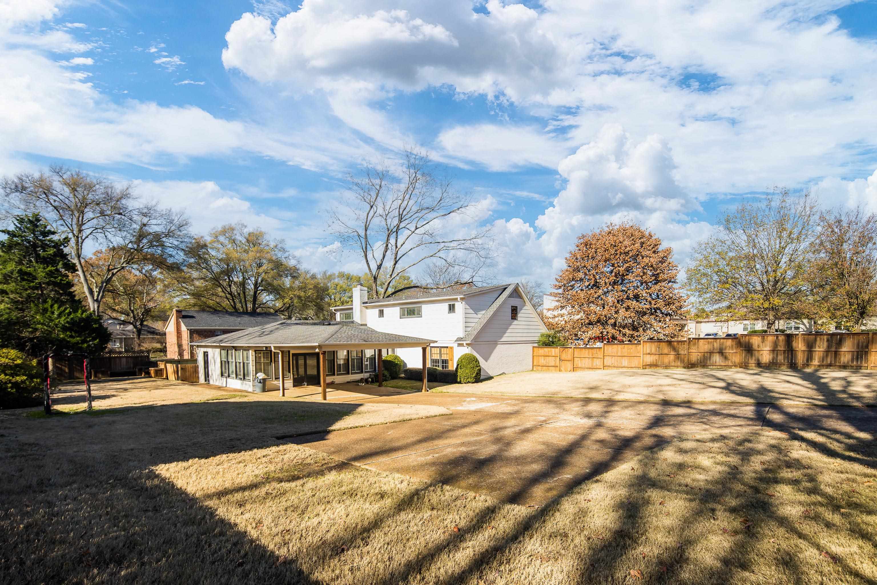 6867 River Birch Road Memphis, TN 38119 - Photo 36 of 40 Rear view of property featuring a patio area and a chimney