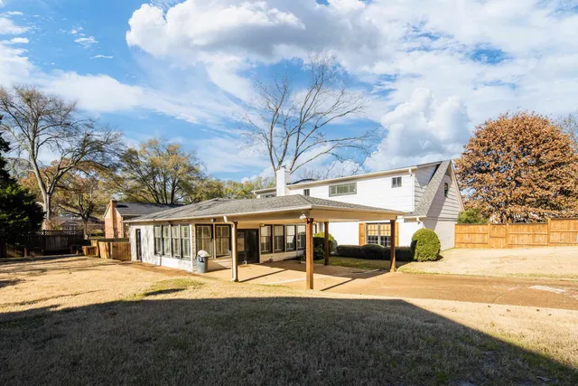 a view of house with outdoor space and trees around