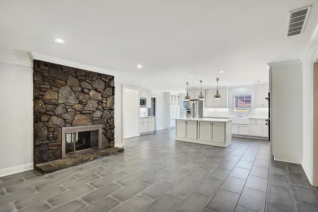 a kitchen with stainless steel appliances a refrigerator sink and cabinets