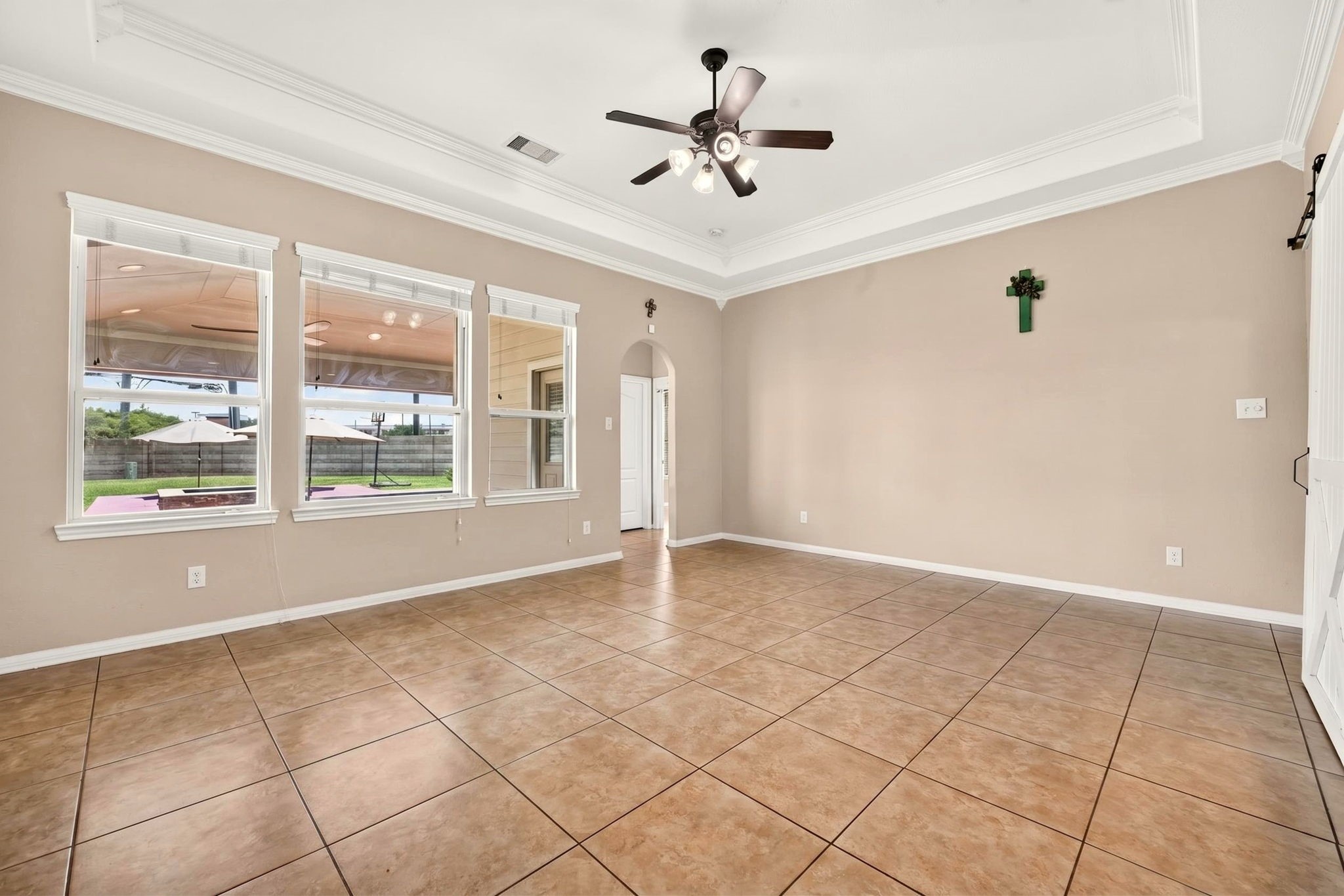 6446 Tea Tree Drive Katy, TX 77494 - Photo 4 of 39 19x15 Living Room -
High recessed ceiling with fan light adds interest and coolness to the space while the view is focused on the pool.