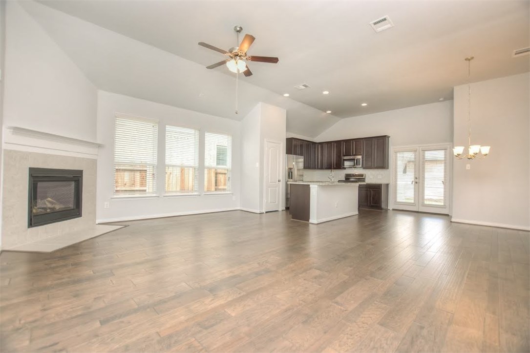 704 Bonnet Boulevard Georgetown, TX 78628 - Photo 8 of 40 High vaulted ceilings in the living room open to the dining and kitchen area.