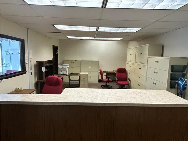 a room with a mirror and cabinets
