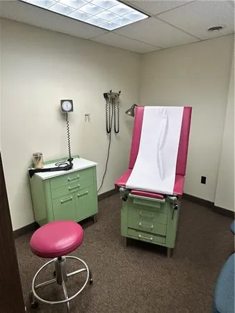 a room with stainless steel appliances table chair and cabinets