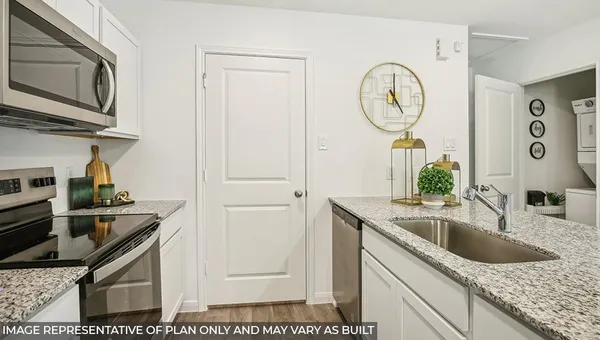 a kitchen with stainless steel appliances granite countertop a sink and a stove