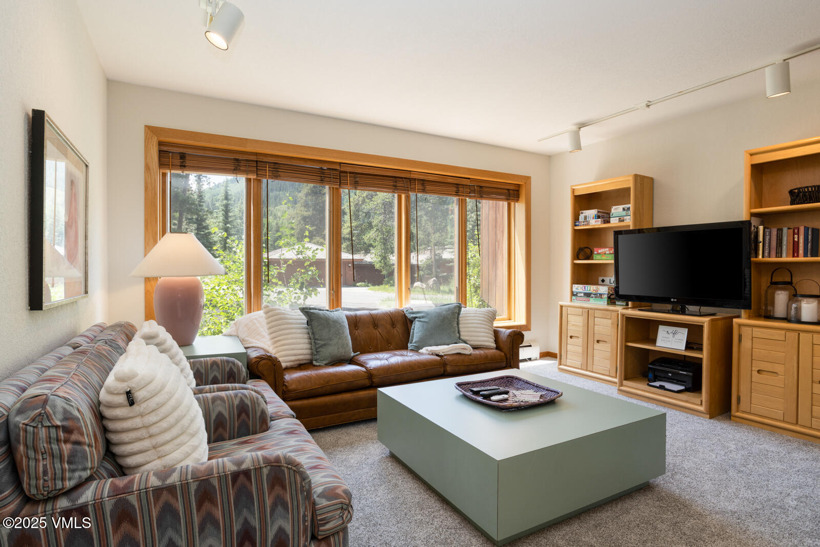 5159 Gore Circle Vail, CO 81657 - Photo 11 of 62 a living room with furniture a flat screen tv and a large window