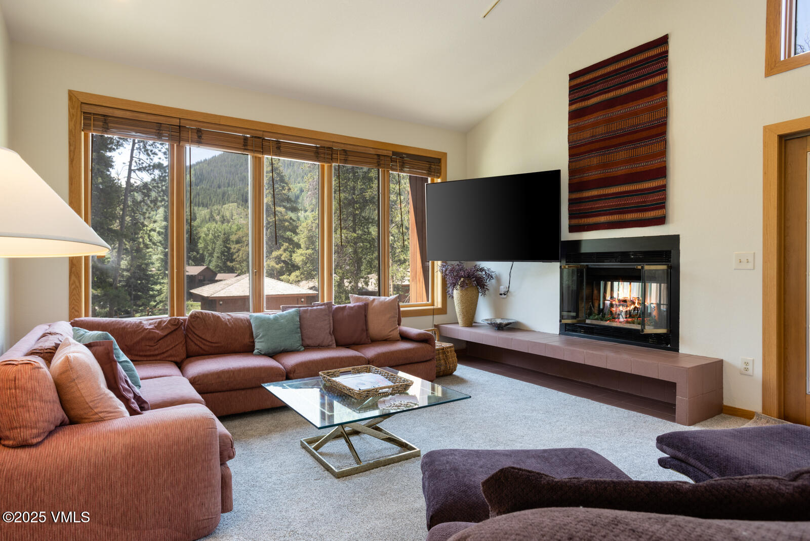5159 Gore Circle Vail, CO 81657 - Photo 15 of 62 a living room with furniture a large window and a fireplace